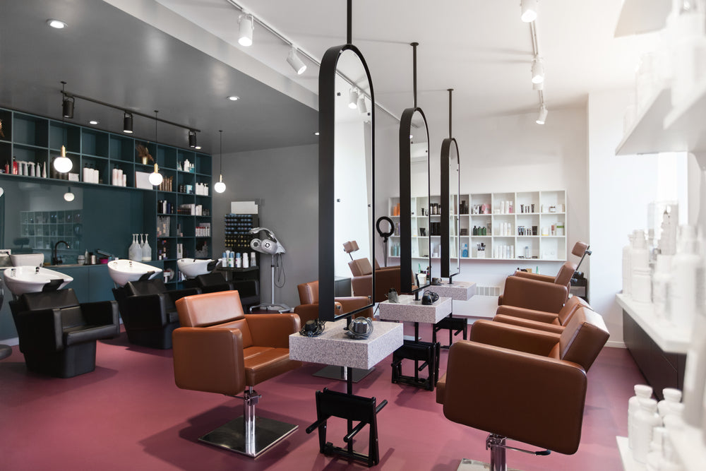 Stylish beauty salon interior. Hairdresser and makeup artist workplaces in one room, creative mirrors